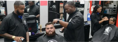 Barber students training in the Washington Barber College floor clinic